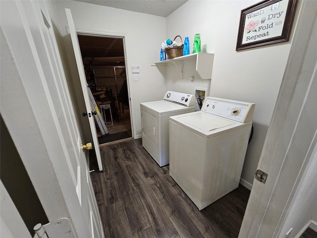 laundry room with washing machine and dryer, dark hardwood / wood-style flooring, and a textured ceiling