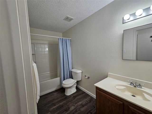 full bathroom with shower / bath combination with curtain, a textured ceiling, toilet, vanity, and hardwood / wood-style flooring