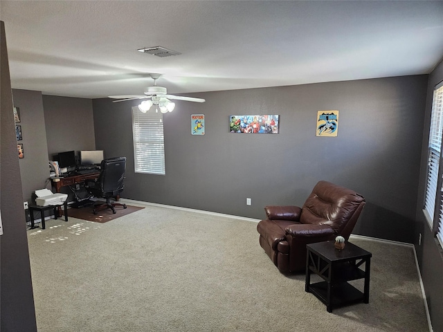 office space with carpet and ceiling fan