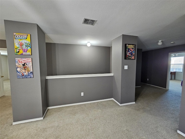 basement featuring carpet floors and a textured ceiling