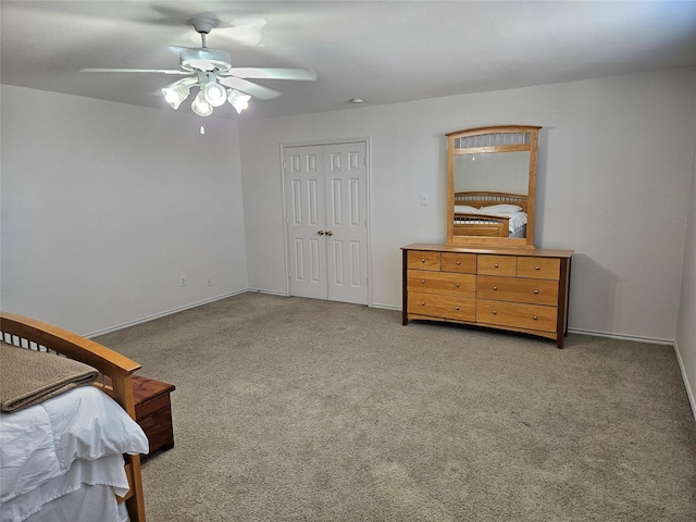 carpeted bedroom featuring ceiling fan and a closet