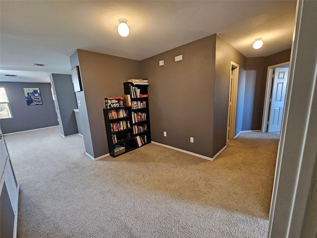 hallway with light colored carpet