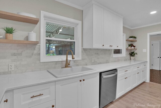 kitchen with dishwasher, white cabinets, light hardwood / wood-style flooring, and sink