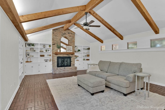 living room featuring lofted ceiling with beams, ceiling fan, wooden walls, and a brick fireplace