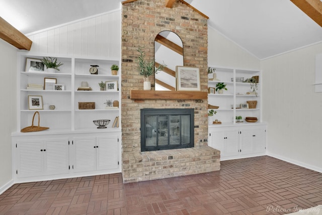 unfurnished living room featuring built in shelves, a fireplace, and high vaulted ceiling