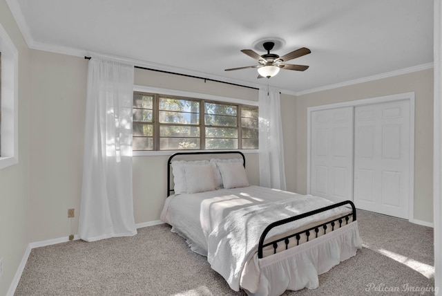 carpeted bedroom featuring a closet, ceiling fan, and ornamental molding