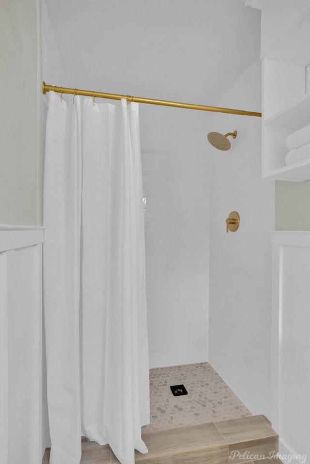 bathroom featuring curtained shower and hardwood / wood-style flooring