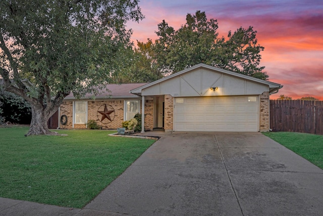 single story home with a garage and a yard