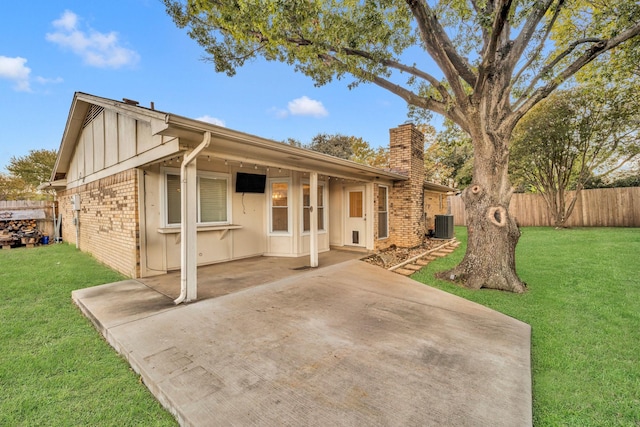 view of front of house featuring a patio, central AC, and a front lawn