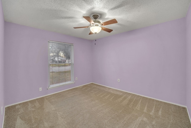 carpeted spare room with a textured ceiling