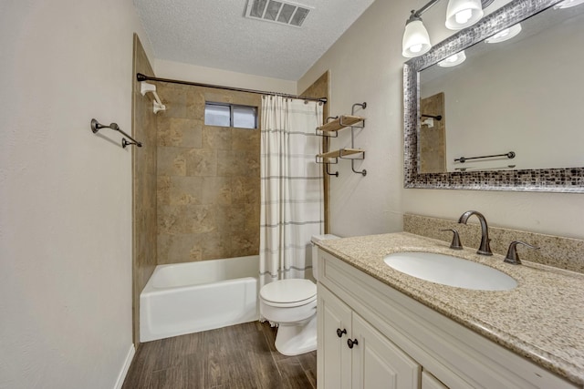 full bathroom with vanity, shower / bathtub combination with curtain, a textured ceiling, and toilet