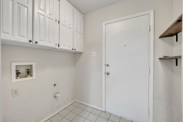 laundry room featuring cabinets, light tile patterned floors, hookup for a washing machine, hookup for an electric dryer, and a textured ceiling