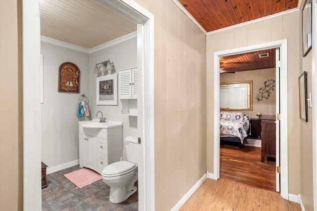 bathroom with crown molding, wood-type flooring, toilet, and wooden ceiling