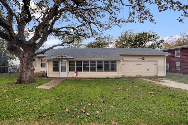 view of front of property featuring a garage and a front yard