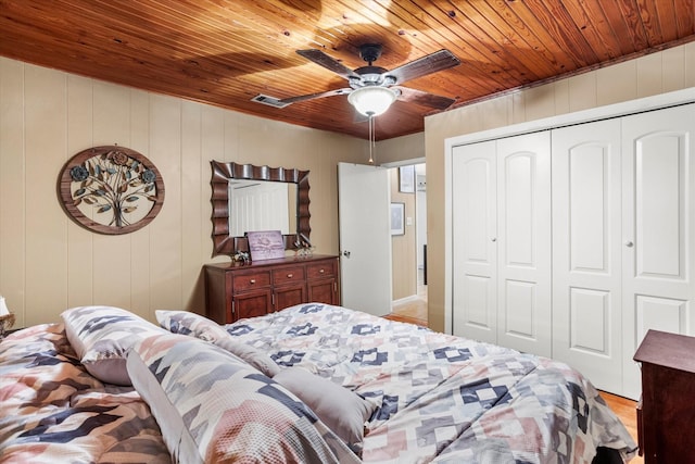 bedroom featuring wooden ceiling, a closet, and ceiling fan