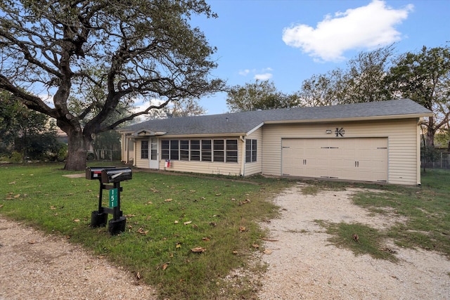 ranch-style home with a garage and a front yard