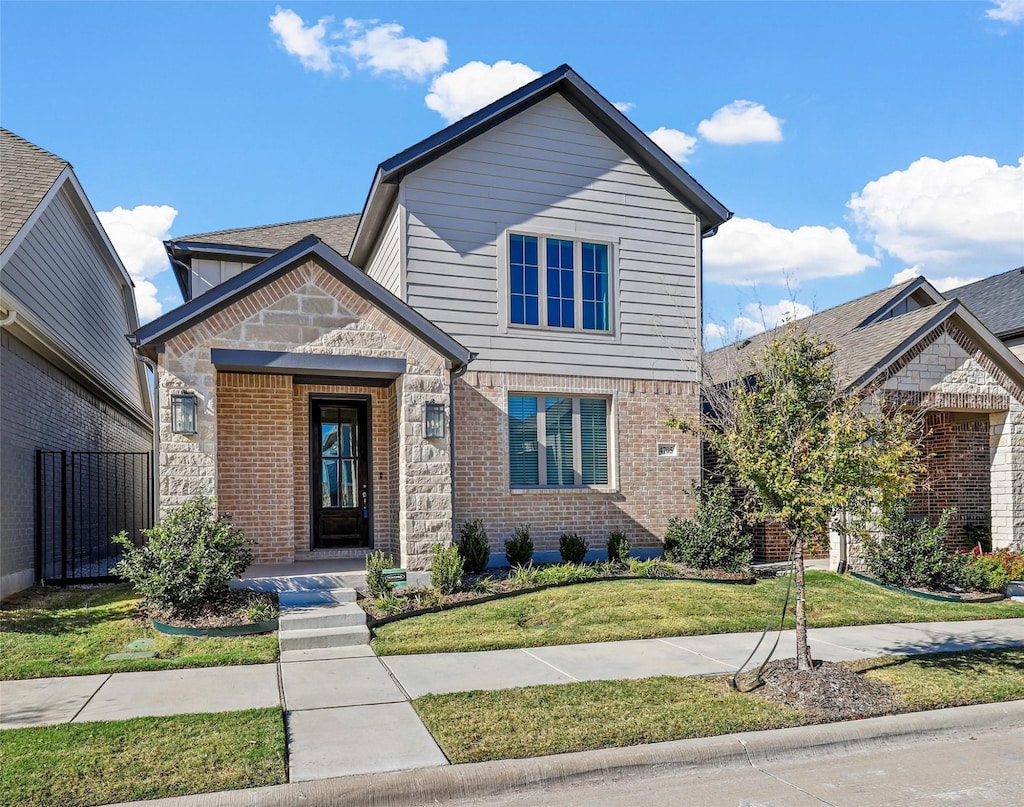 4705 Alliance St, Haltom City, TX 76117 - view of front facade featuring a front yard, stone siding, and brick siding
