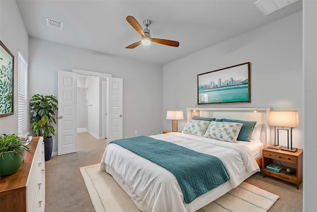 carpeted bedroom featuring ensuite bathroom and ceiling fan