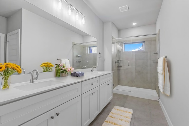 bathroom with tile patterned flooring, vanity, and an enclosed shower