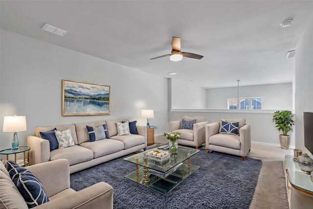 living room featuring carpet floors and ceiling fan