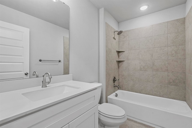 full bathroom with toilet, vanity, and tiled shower / bath