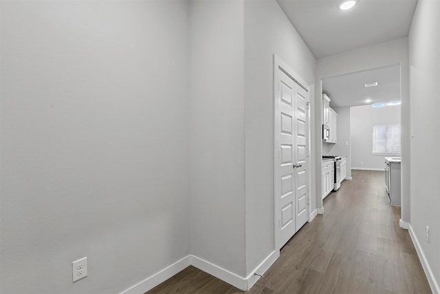 hallway with hardwood / wood-style floors