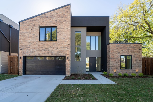 contemporary house with a garage and a front lawn