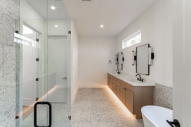 bathroom featuring vanity, tile walls, and independent shower and bath