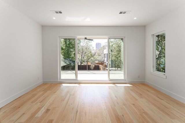 unfurnished room with light hardwood / wood-style floors