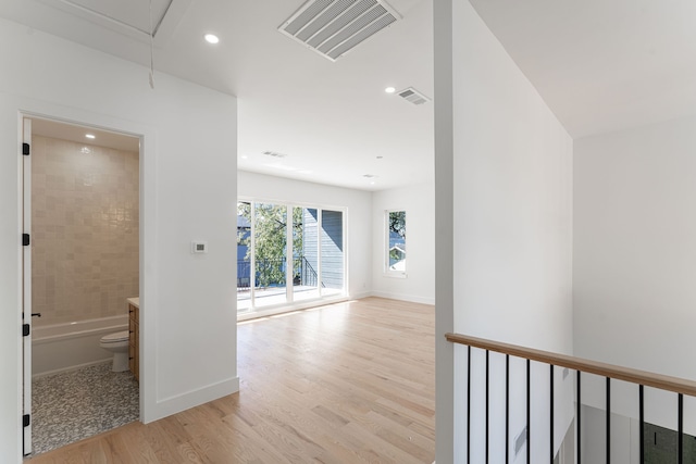 hallway with light hardwood / wood-style flooring