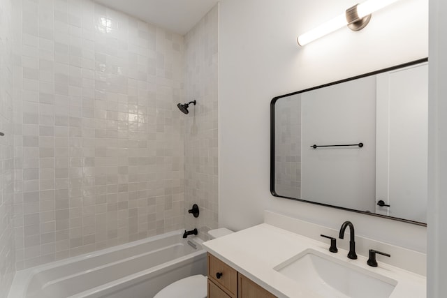 full bathroom with vanity, tiled shower / bath combo, and toilet