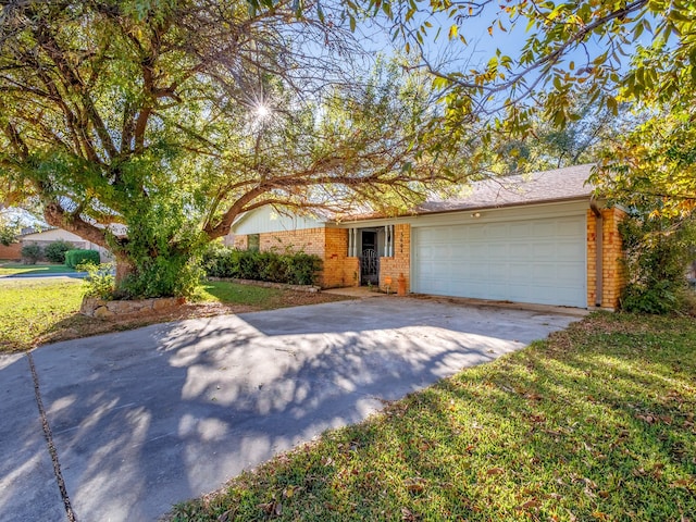 view of front of home featuring a garage and a front lawn