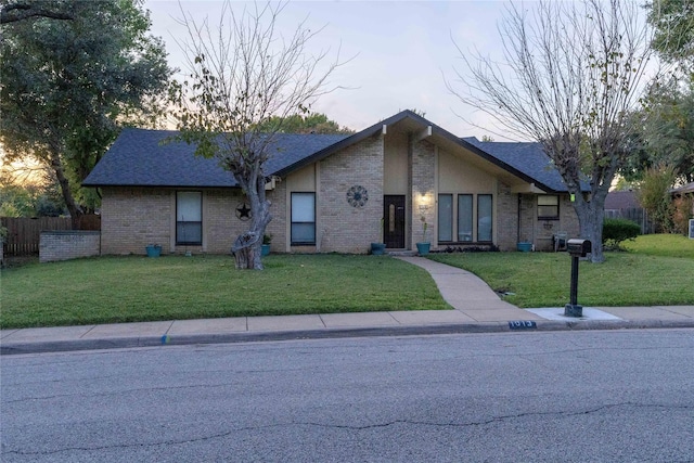 ranch-style home with a lawn