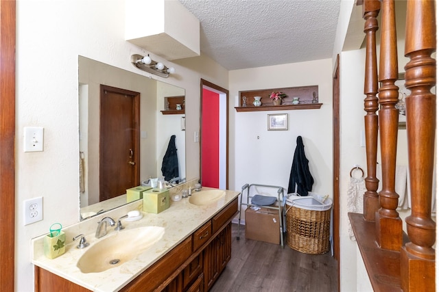 bathroom with vanity, hardwood / wood-style floors, and a textured ceiling