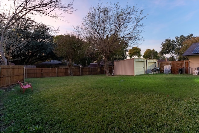 yard at dusk with a storage shed