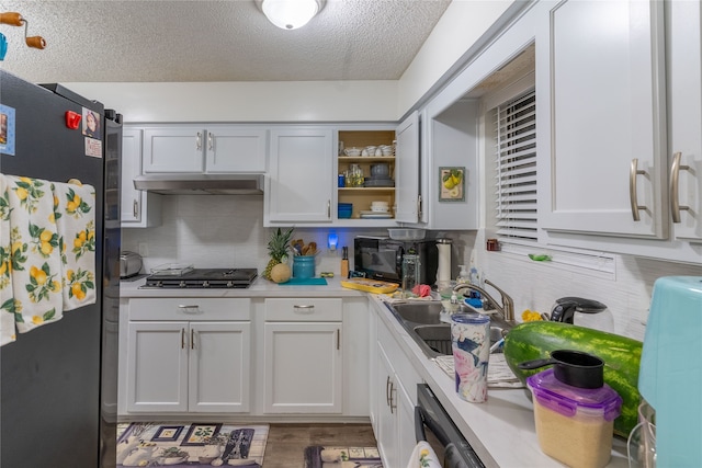 kitchen with dark hardwood / wood-style flooring, white cabinetry, sink, and appliances with stainless steel finishes