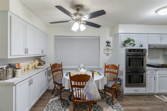 dining space with a textured ceiling, dark hardwood / wood-style floors, and ceiling fan