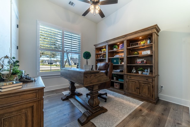 home office featuring ceiling fan, dark wood-type flooring, and lofted ceiling