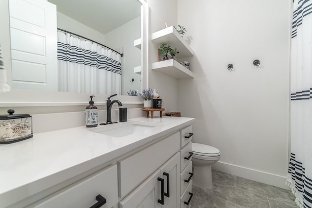 bathroom featuring tile patterned flooring, vanity, and toilet