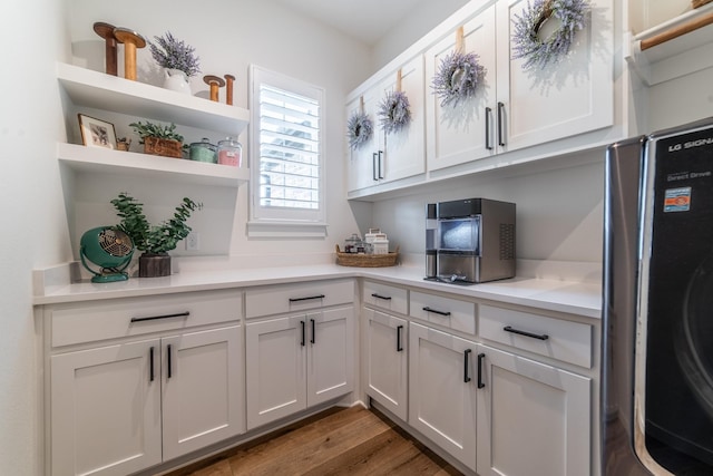 kitchen featuring washer / clothes dryer, white cabinets, and dark hardwood / wood-style floors