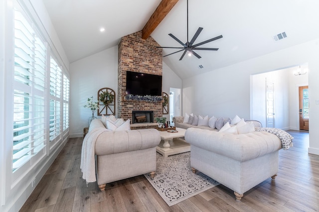 living room with hardwood / wood-style flooring, ceiling fan, a healthy amount of sunlight, and beam ceiling