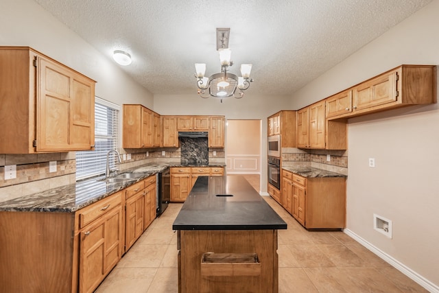 kitchen featuring a textured ceiling, sink, a center island, and black appliances