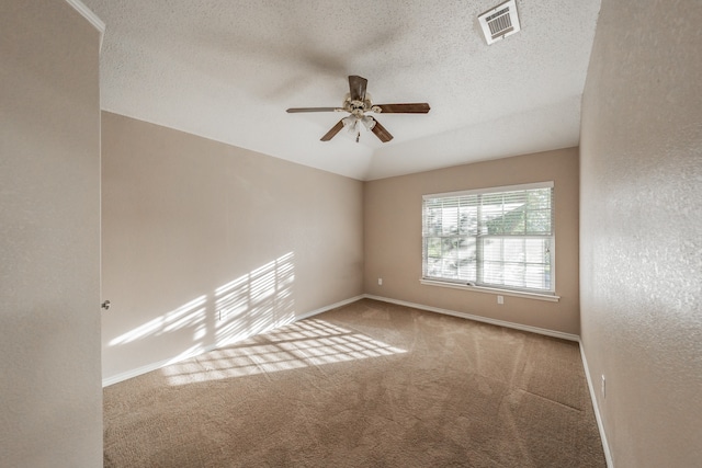 spare room featuring ceiling fan, carpet floors, and a textured ceiling