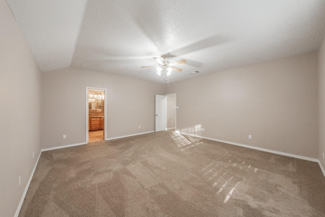 carpeted spare room with lofted ceiling, ceiling fan, and a textured ceiling