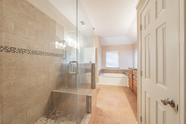 bathroom featuring a textured ceiling and plus walk in shower