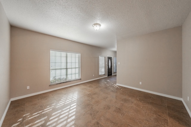 spare room with a textured ceiling