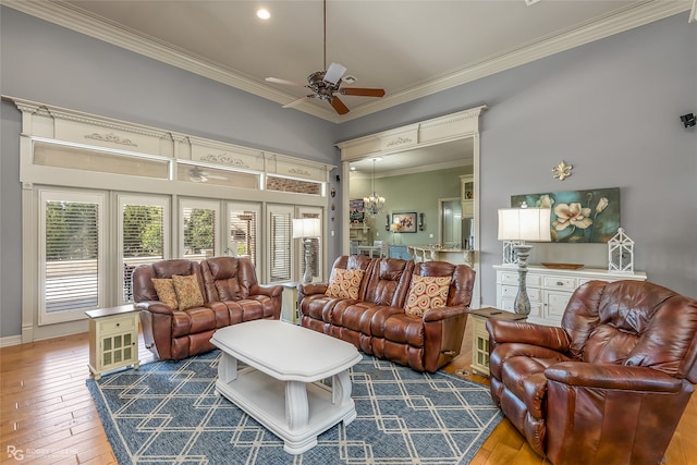 living room with hardwood / wood-style flooring, ceiling fan with notable chandelier, and crown molding