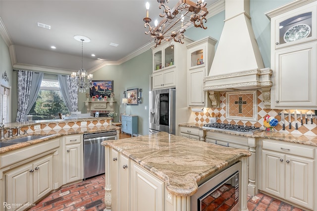 kitchen with custom exhaust hood, a center island, an inviting chandelier, appliances with stainless steel finishes, and decorative light fixtures