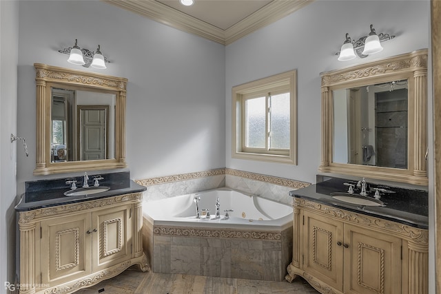 bathroom with vanity, ornamental molding, and tiled tub