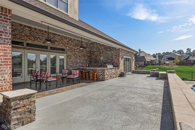 view of patio with ceiling fan and area for grilling